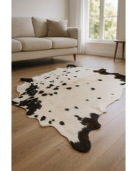Black Cowhide Print Handwoven Rug – Modern Accent Low Angle View — cowhide area rug 11